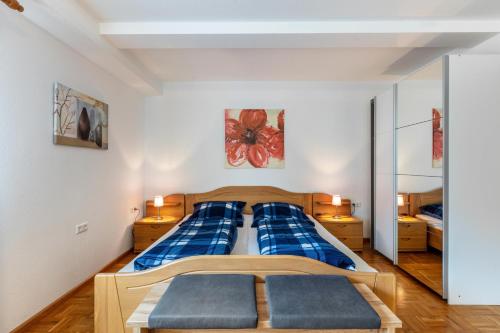 a bedroom with a blue bed with blue pillows at Ferienwohnung Sägegasse, Typ A in Münstertal