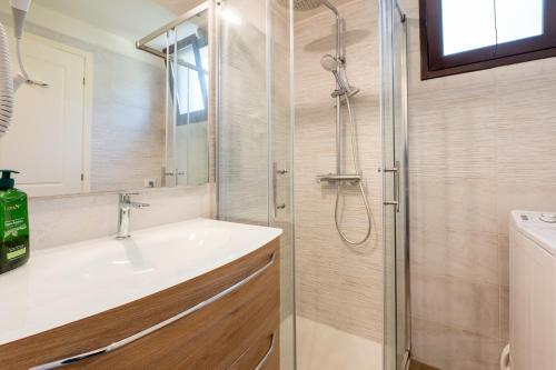 a bathroom with a sink and a shower at Cefalù Seaside Pool Villa in Cefalù