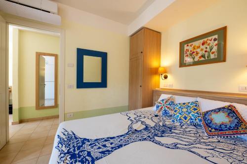 a bedroom with a large bed with blue and white at Cefalù Seaside Pool Villa in Cefalù