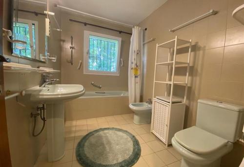 a bathroom with a toilet and a sink and a shower at Casa Harriet in Mijas