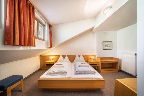 a room with a bed and a staircase at Manuel's App Watschinger - Frieda in Sesto