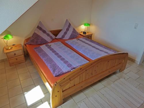 a bed in a room with two night stands and two lamps at Haus Sonntag in Frickingen
