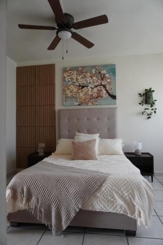 a bedroom with a bed with a ceiling fan at Departamento zona central in La Paz