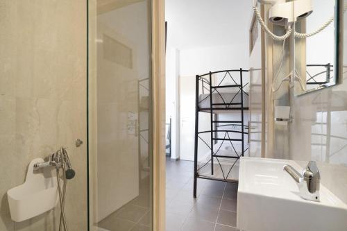 a bathroom with a shower and a white sink at Iguana studio 10 in Preveza