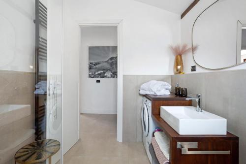 a bathroom with a sink and a mirror at Agriturismo Per Caso in Carignano