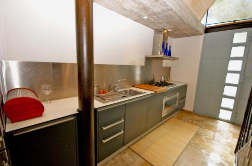 a kitchen with a sink and a counter top at Sa Portassa in Felanitx
