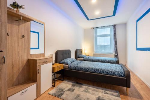 two beds in a room with a window at Gera Apartment in Gera