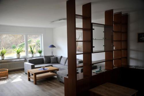 a living room with a couch and a table at Rothaarsteig Ferienhaus in Kirchhundem