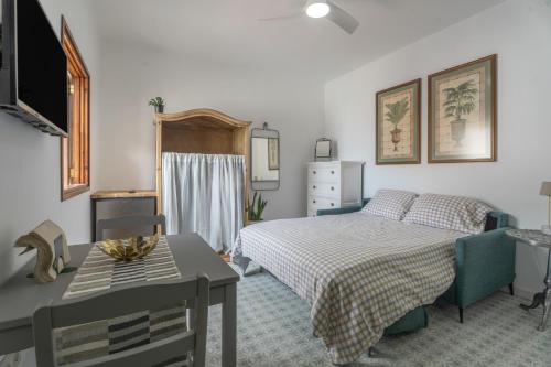 a bedroom with a bed and a table and a desk at Studio Tagoro in Guía de Isora