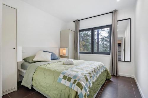 a bedroom with a bed and a large window at Gerês Hideaway in Vilar da Veiga
