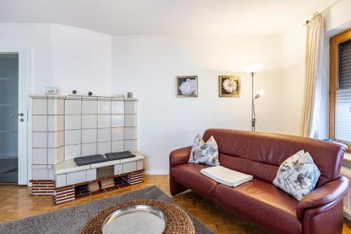 a living room with a brown leather couch at Haus Regina in Löffingen
