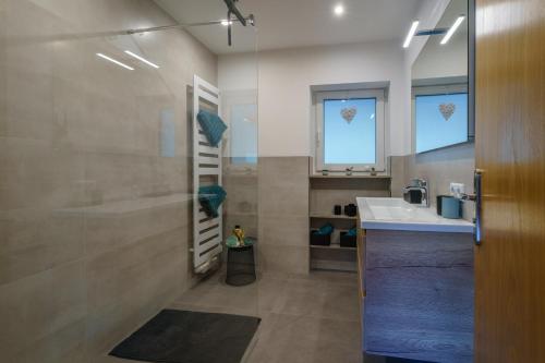 a bathroom with a shower and a sink at Brandenkopfblick in Oberharmersbach