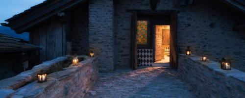 a lit up room with candles on a stone wall at Confrérie du Moyen Âge in Verrayes