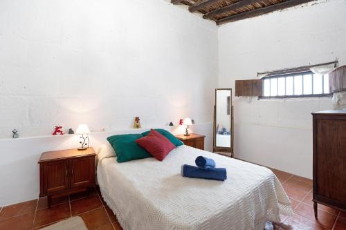 a bedroom with a bed with a blue box on it at Casa El Drago in Arico