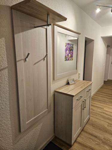 a room with a closet with a wooden door at Ferienoase Weitblick in Rinteln