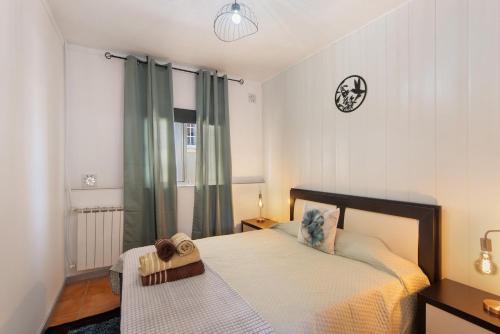 a bedroom with a bed and a clock on the wall at Casa Amarela in Ponte de Vagos