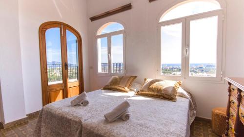 a bedroom with a bed with two pillows on it at Na Penyal Ref 246 in Cala Millor