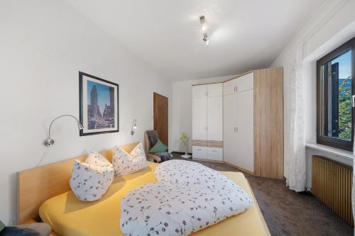a bedroom with a yellow bed with pillows on it at Katharina in Lana