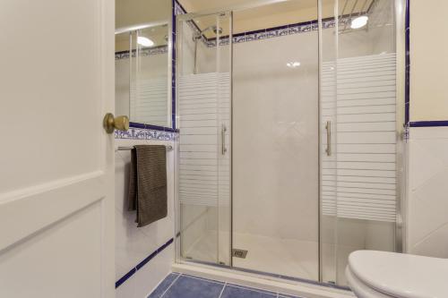 a glass shower in a bathroom with a toilet at Oasis Duna _ Casa Martineli Pool in Corralejo