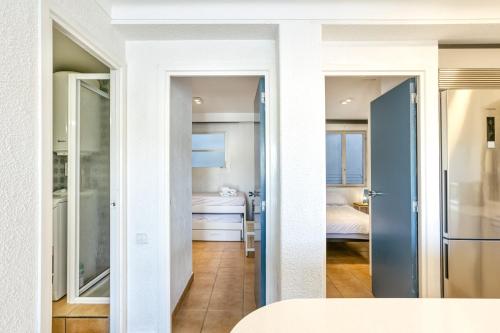 a view of a room with a bedroom and a bed at 1a Linea mar port Llafranch in Llafranc