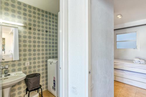 a small bathroom with a sink and a sink at 1a Linea mar port Llafranch in Llafranc