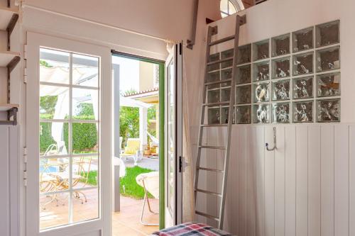 a room with a door open to a patio at Casa de Jardim in Ponte de Sor