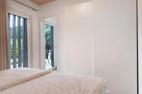 a bedroom with a bed and a large window at Wanderlust in Todtnau