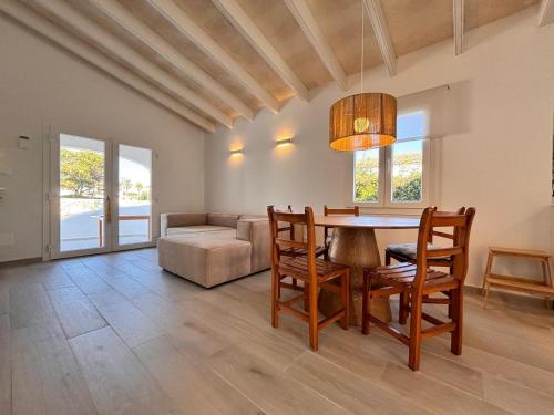 a living room with a table and chairs and a couch at Casa Menorquina Son Moix in Ciutadella