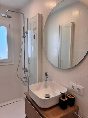 a bathroom with a sink and a mirror at Casa Menorquina Son Moix in Ciutadella