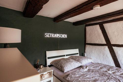a bedroom with a bed and a green wall at Lauterbach im Herzen der Altstadt in Lauterbach