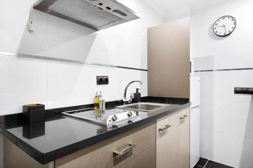 a kitchen with a sink and a refrigerator at Estudio centro de Torremolinos in Torremolinos