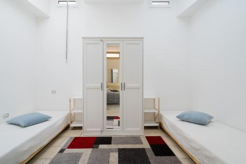two beds in a room with white walls at Villa I Gabbiani a Otranto in Otranto
