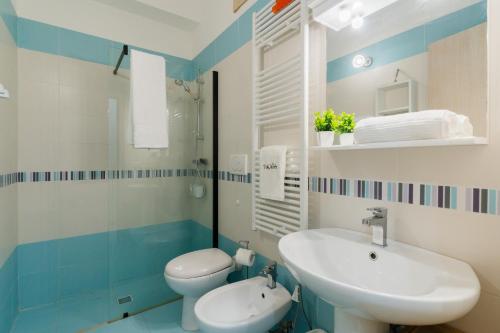a blue and white bathroom with a sink and a toilet at Villa I Gabbiani a Otranto in Otranto