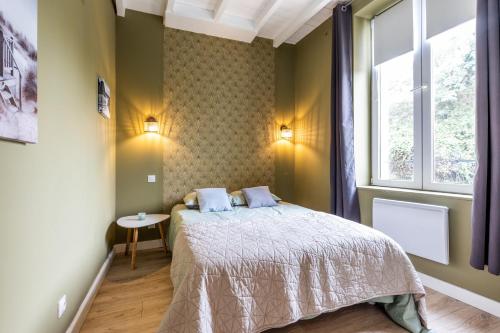 a bedroom with a bed and a window at Demeure en pierre avec piscine in Vertheuil-en-Médoc