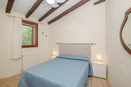 a bedroom with a blue bed and a mirror at Residenza Conti Porto Istana in Porto Istana