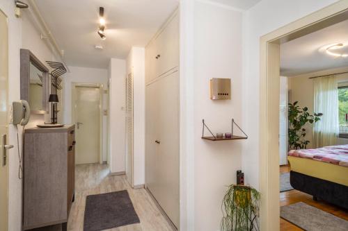 a hallway with a bedroom and a bed in a room at Mein lieber Schwan in Lindau