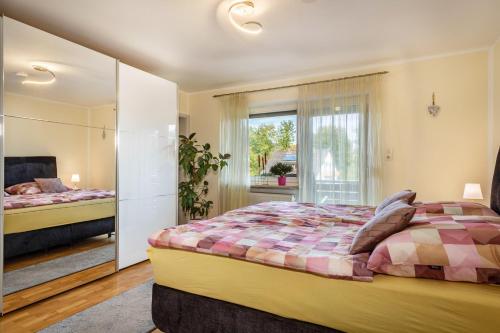 a bedroom with two beds and a large window at Mein lieber Schwan in Lindau