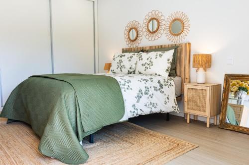 a bedroom with a bed and a mirror on the wall at Aurora do Furadouro l in Ovar