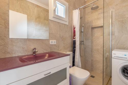 a bathroom with a sink and a toilet and a shower at Bungalow Cala Dor 27 in Cala d´Or