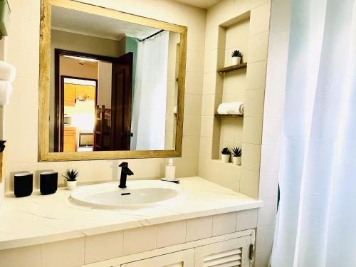 a bathroom with a sink and a mirror at Casa N's in Albufeira