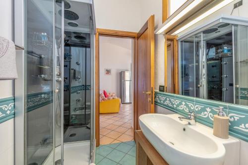 a bathroom with a sink and a shower at 1 Appartamento Lu Impostu in San Teodoro
