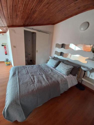 a bedroom with a large bed with a wooden ceiling at D'ouro Relax - Douro Vinhateiro in Sanfins do Douro