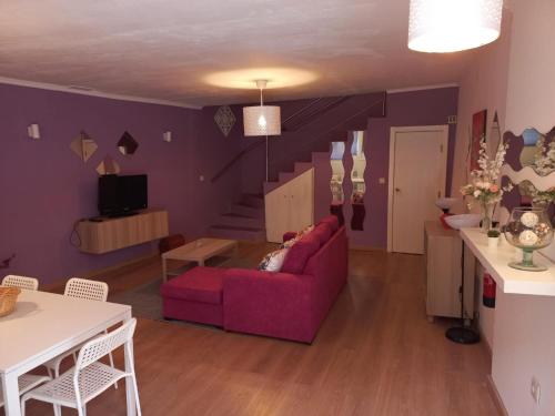 a living room with a purple couch and a table at D'ouro Relax - Douro Vinhateiro in Sanfins do Douro