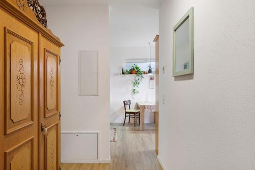a hallway with a door and a table in a room at Am Rothen Hang in Oberelsbach