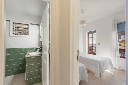 a bathroom with a sink and a table in a room at Orion Beach in Puerto