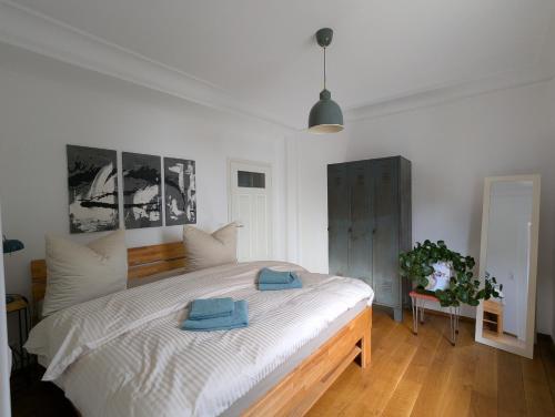 a bedroom with a large bed with two towels on it at Ferienwohnung Lichtenstein in Lichtenstein