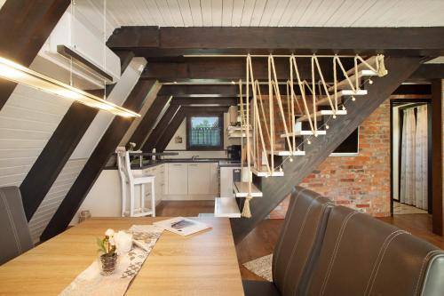 a dining room with a table and a staircase at Ferienhaus Exquisit in Immenstaad am Bodensee