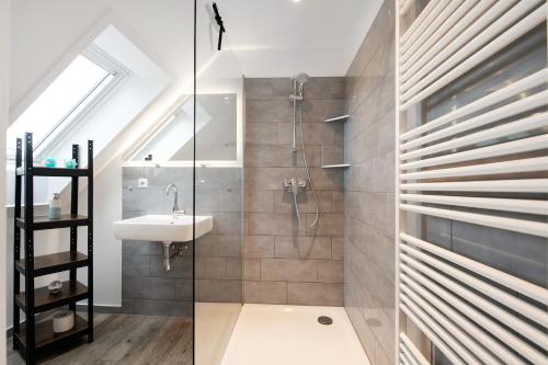 a bathroom with a shower and a sink at Haus Kirchenblick in Kalkhorst