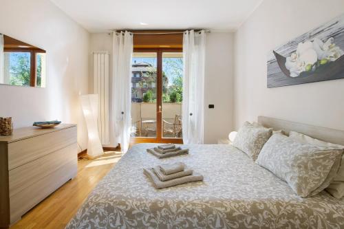 a bedroom with a bed with two towels on it at Casa Rosada Monza Autodromo in Nova Milanese