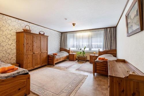 a large room with two beds and a window at Haus am Markt Fewo 2 in Schöningen
